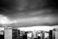 Grayscale shot of the city of Patras in Greece under storm clouds Royalty Free Stock Photo
