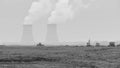 Grayscale shot of construction vehicles with silhouettes of towers in the background.