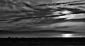 Grayscale shot of dark moody cloudscape over the sea