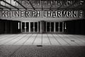 Grayscale shot of the entrance and illuminated sign of the Koelner Philharmonie in Cologne, Germany