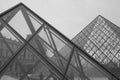 Grayscale shot of the exterior of the Louvre Pyramid in Paris, France
