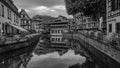 grayscale shot Famous Half Timbered-house Petite France District with water reflection