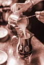 Grayscale shot of a female barista at work preparing milk Royalty Free Stock Photo