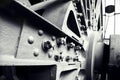 Grayscale shot of gear mechanisms of a locomotive engine, emphasizing intricate details of machinery