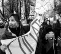 Grayscale shot of a group of angry COP26 protestors marching in the streets of Glasgow, Scotland