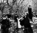 Grayscale shot of a group of angry COP26 protestors marching in the streets of Glasgow, Scotland