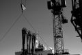 Grayscale shot of industrial towers and a tank overfill alarm Royalty Free Stock Photo