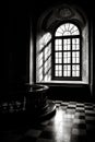Grayscale shot of an interior of a vintage house with an open window Royalty Free Stock Photo