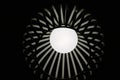 Grayscale shot of a lit lamp on the ceiling