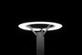 Grayscale shot of a lit street lamp isolated on a black background at night Royalty Free Stock Photo