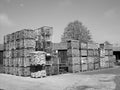 Grayscale shot of a lot of storage boxes with firewood in a factory at daytime