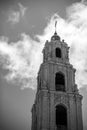 Grayscale shot of a majestic stone church tower.