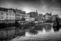 Grayscale shot of the Millrace Channel surrounded by buildings in Opole, Poland
