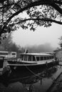 Grayscale shot of a moored boat at a city port