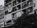 Grayscale shot of an old apartment with posters on Nguyen Hue street in Ho Chi Minh City, Vietnam