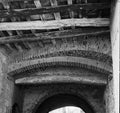 Grayscale shot of an old archway with wooden ceiling Royalty Free Stock Photo