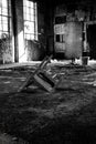 Grayscale shot of an old chair on an abandoned building - perfect for horror movies Royalty Free Stock Photo