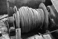 Grayscale shot of an old and dirty rope spool Royalty Free Stock Photo