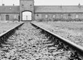 Grayscale shot of the old empty railroad track in Auschwitz concentration camp