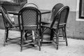 Grayscale shot of the outdoor furniture with a table and rattan chairs Royalty Free Stock Photo
