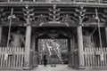 Grayscale shot of a person entering a temple in Miyajima, Japan