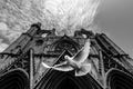 Grayscale shot of a pigeon flying in front of the Gazimausa Lala Mustafa Pasa Cami
