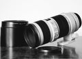 Grayscale shot of a professional DSLR camera lens on the table Royalty Free Stock Photo