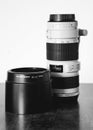 Grayscale shot of a professional DSLR camera lens on the table Royalty Free Stock Photo