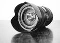 Grayscale shot of a professional DSLR camera lens on the table Royalty Free Stock Photo
