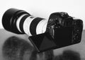 Grayscale shot of a professional DSLR camera on the table