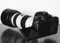 Grayscale shot of a professional DSLR camera on the table