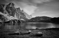 Grayscale shot of the rocky mountains reflecting in the lake, Lago Rienza, Italy, Europe