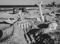 Grayscale shot of sand toy shovel and rake at the beach Royalty Free Stock Photo