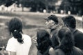 Grayscale shot of a senior man giving instructions to a group of teenagers