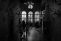 Grayscale shot of silhouettes of people visiting the Ksiaz Castle