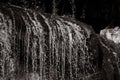 Grayscale shot of a small waterfall in a forest Royalty Free Stock Photo