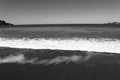 Grayscale shot of soft ocean waves with foam Royalty Free Stock Photo