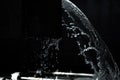 Grayscale shot of splashing water in the darkness Royalty Free Stock Photo