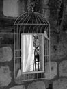 Grayscale shot of a square mirror hanging from the wall