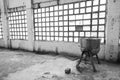 Grayscale shot of a square windows and a kettle inside an old abandoned industrial building Royalty Free Stock Photo