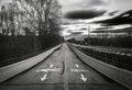 Grayscale shot of a street scene with directional arrows and trees in Linwood, North Carolina Royalty Free Stock Photo