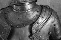 Grayscale shot of the upper part detail of the armor of a medieval knight