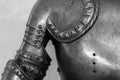 Grayscale shot of the upper part detail of the armor of a medieval knight