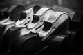 Grayscale shot of various violins aligned on the display of a  musical instrument shop Royalty Free Stock Photo