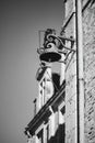 Grayscale shot of vintage brass bell hanging on exterior wall Royalty Free Stock Photo