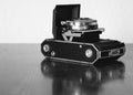 Grayscale shot of a vintage Kodak film camera on the table