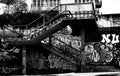 Grayscale of a staircase my the metro with graffiti walls in Prague during the daytime