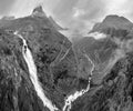 Grayscale. Summer Trollstigen serpentine mountain path road and Stigfossen waterfall view from The Trolls Path Viewpoint, Norway Royalty Free Stock Photo