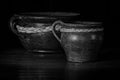 Grayscale of two old beautiful clay pots on a dark background Royalty Free Stock Photo