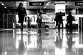 Grayscale of underground passage busy with people getting to and from a metro station. Royalty Free Stock Photo